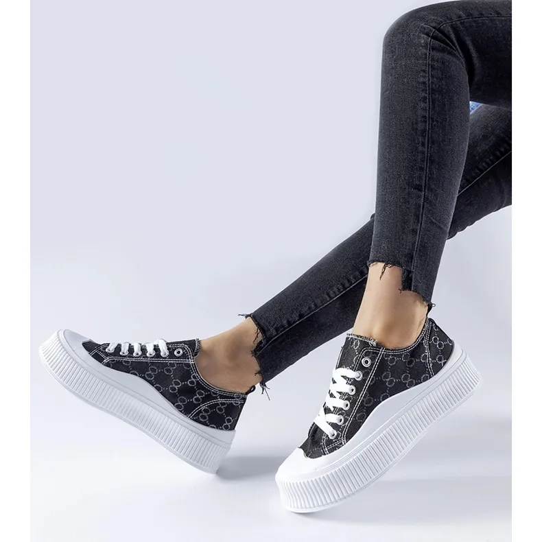 Black sneakers decorated with the Cavi monogram